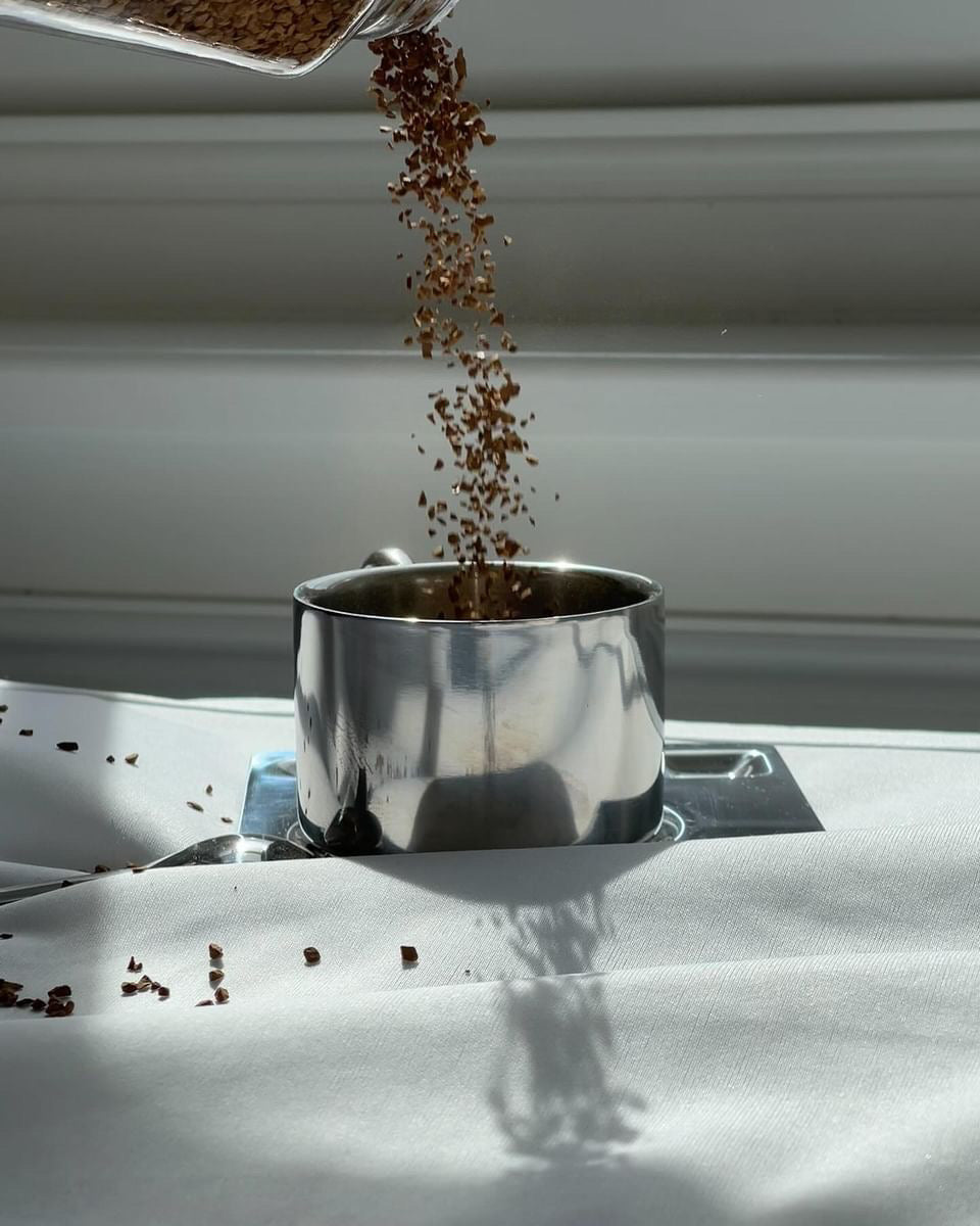 scandi stainless steel coffee mug with spoon and plate, making a coffee